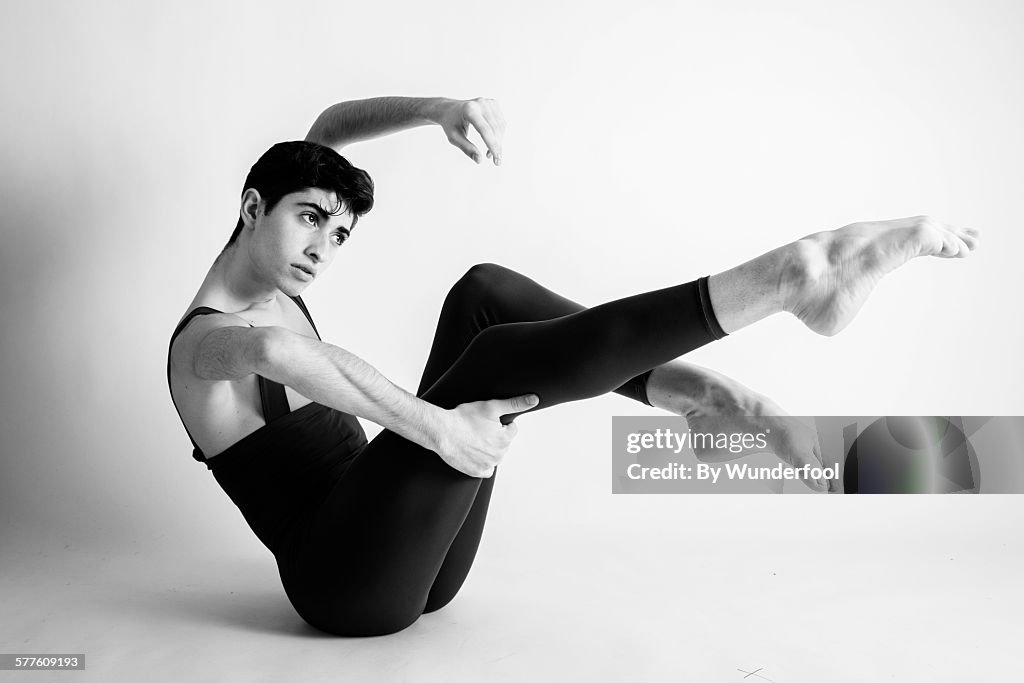 Male ballet dancer in tights with his legs up