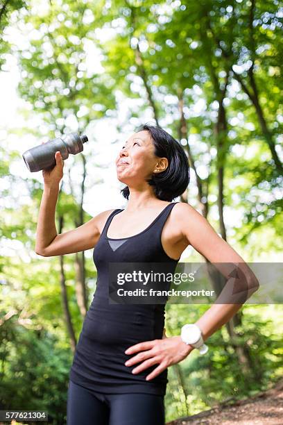 woman refreshment herself on the nature after have been hiking - pictures of containers seized by customs stock pictures, royalty-free photos & images