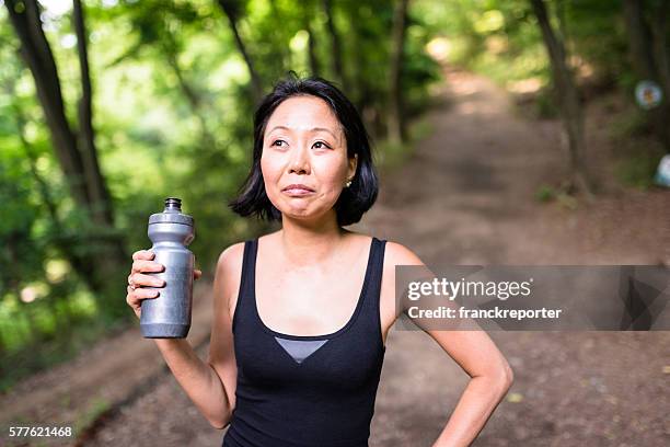 woman refreshment herself on the nature after have been hiking - pictures of containers seized by customs stock pictures, royalty-free photos & images