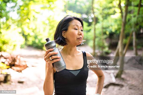 woman refreshment herself on the nature after have been hiking - pictures of containers seized by customs stock pictures, royalty-free photos & images