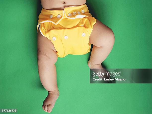 baby wearing yellow cloth nappy or diaper - reusable diaper stock pictures, royalty-free photos & images