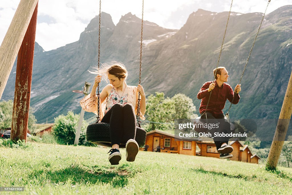 Two people  on the swing