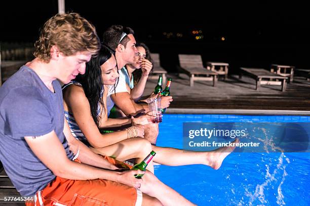 pool party drinking beer - pool party night stock pictures, royalty-free photos & images