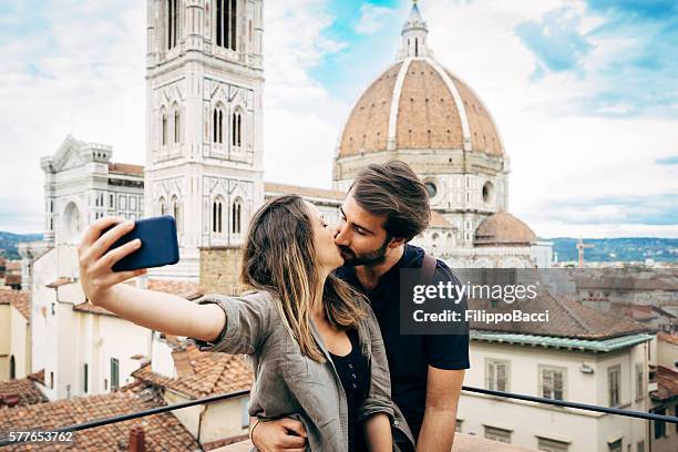 young couple kissing in front of florence's cathedral - marriage italian style stock pictures, royalty-free photos & images