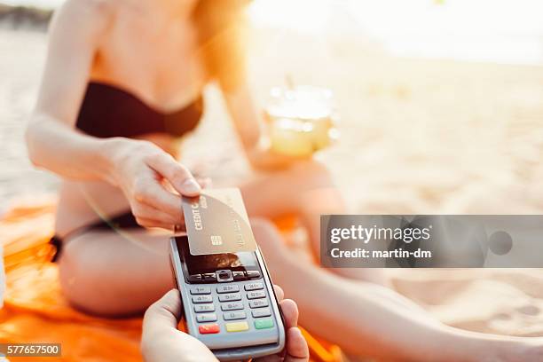 tourist paying contactless on a vacation - handing over credit card stock pictures, royalty-free photos & images