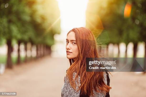 woman in the park - portrait looking over shoulder stock pictures, royalty-free photos & images