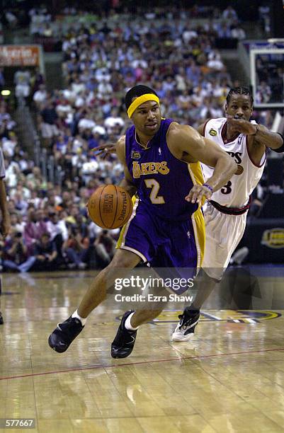Derek Fisher of the Los Angeles Lakers drives to the basket in game four of the NBA Finals against the Philadephia 76ers at the First Union Center in...