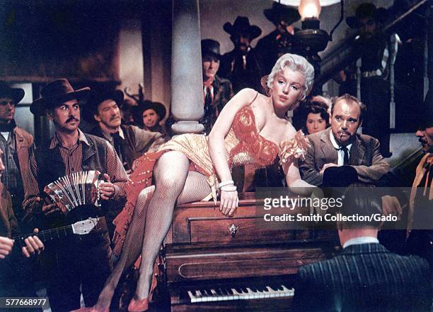 Marilyn Monroe reclining on a piano during a film, 1950.