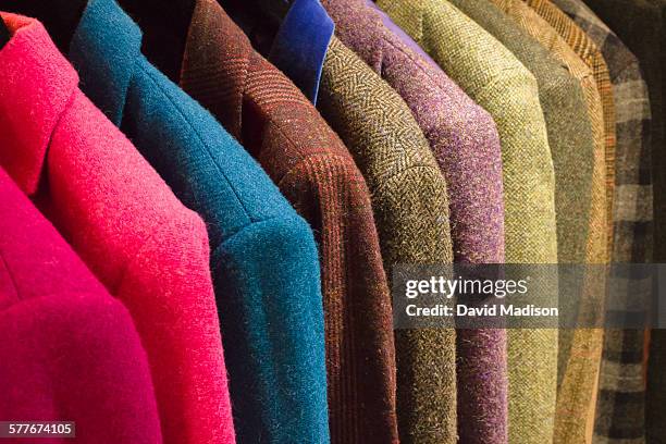 display of harris tweed jackets. - coat hanging stock pictures, royalty-free photos & images