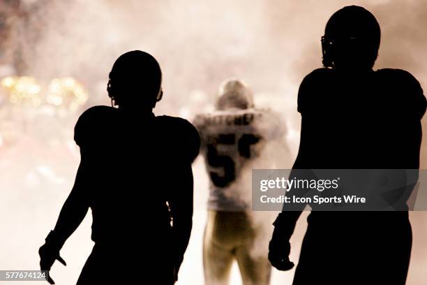 New Orleans Saints linebacker Marvin Mitchell runs out during player introductions as teammates look on before kickoff of a preseason game between...