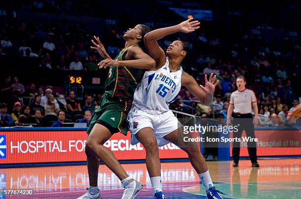 Liberty's center Kia Vaughn and Storm's center Janell Burse battle for position in the paint during a WNBA basketball game between the New York...