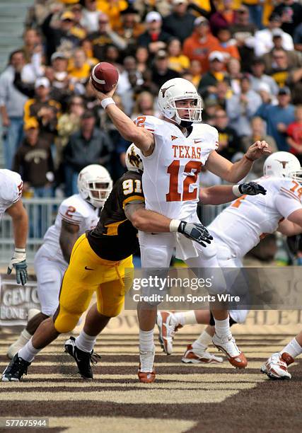 Colt McCoy of the University of Texas avoids a safety and Wyoming DT John Fletcher during the game. The University of Texas defeated the University...