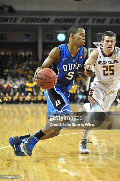 Duke Blue Devils forward Rodney Hood drives past Boston College Eagles guard Joe Rahon to the basket during the Duke Blue Devils game against the...