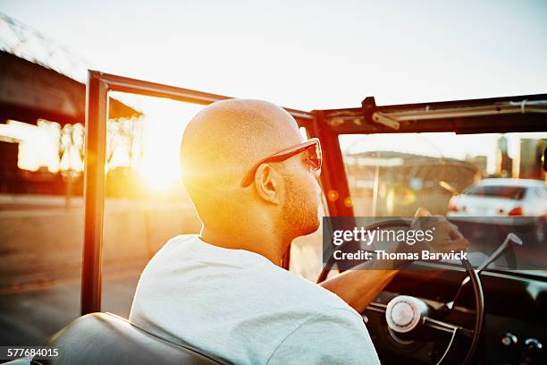 man driving convertible on summer evening - convertible top stock pictures, royalty-free photos & images