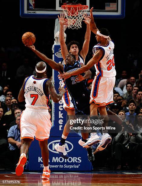 Al Harrington, Danilo Gallinari and Jared Jeffries of the New York Knicks guard Wesley Matthews of the Utah Jazz in the first half at Madison Square...