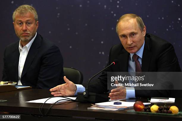 Russian President Vladimir Putin speaks as billionaire and businessman Roman Abramovich looks on during a meeting with top businessmen while visiting...