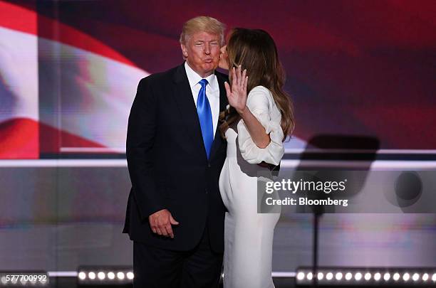 Donald Trump, presumptive 2016 Republican presidential nominee, left, receives a kiss on the cheek from his wife Melania Trump during the Republican...