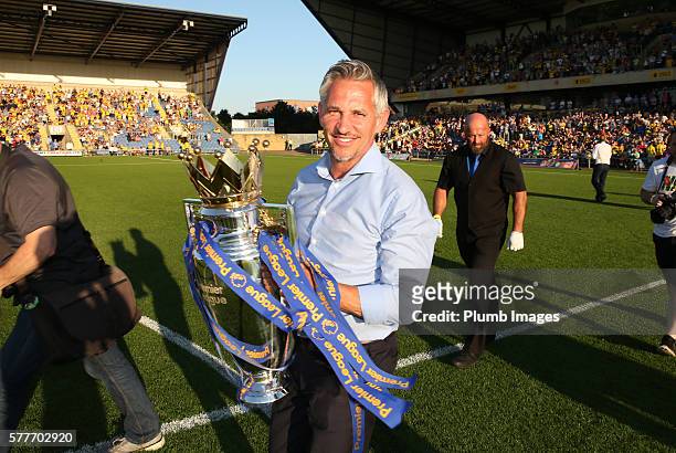 Former Leicester City player and "Match of the Day" host Gary Lineker carries the Premier League trophy ahead of the pre season friendly between...