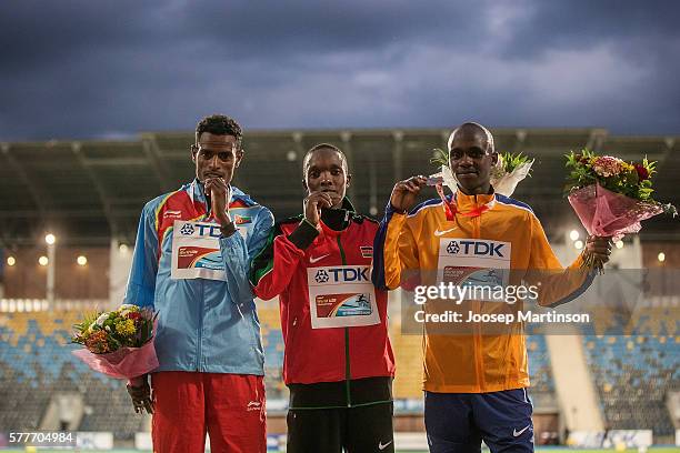 Aron Kifle from Eritrea, Rodgers Chumo Kwemoi from Kenya and Jacob Kiplimo from Uganda celebrate on the podium after men's 10000 meters final during...