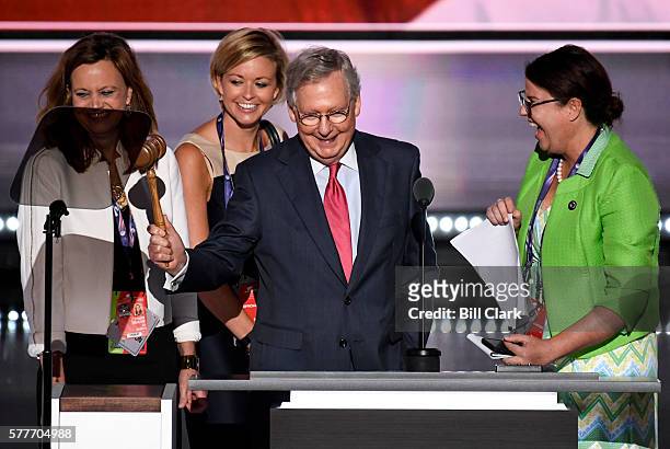 Senate Majority Leader Mitch McConnell and his staff reacts to the booming noise made by the gavel as he tests out the podium on stage before the...