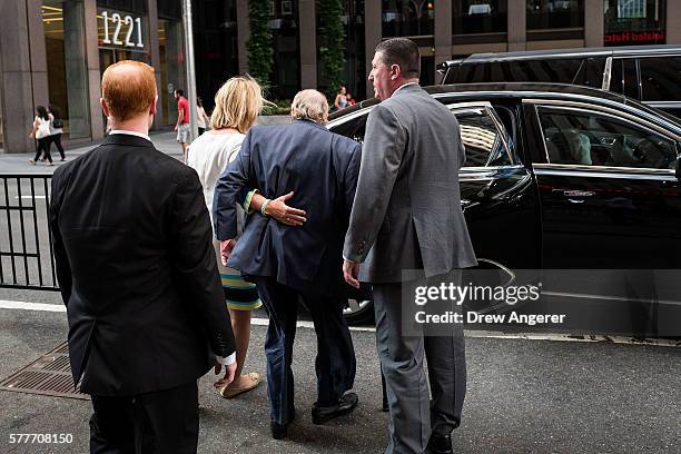 Fox News chairman Roger Ailes is helped to his car by his wife Elizabeth Tilson as they leave the News Corp building, July 19, 2016 in New York City....