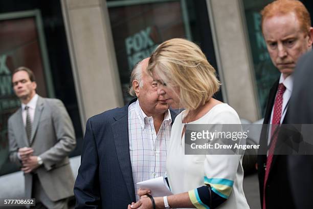 Fox News chairman Roger Ailes tries to avoid the camera as he walks with his wife Elizabeth Tilson and security detail as they leave the News Corp...