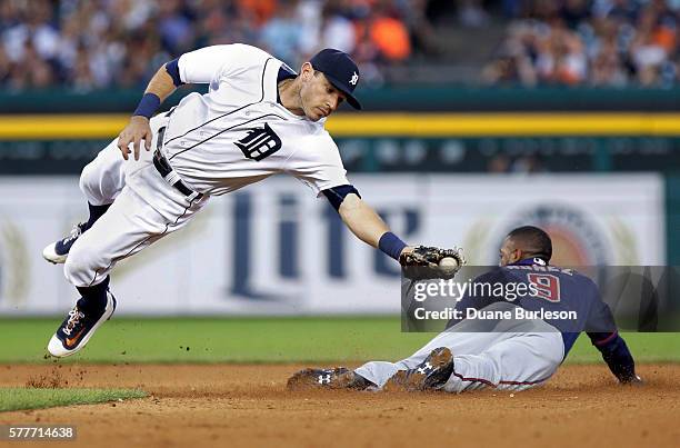 Second baseman Ian Kinsler of the Detroit Tigers makes a diving catch of a pickoff throw as Eduardo Nunez of the Minnesota Twins steals second base...