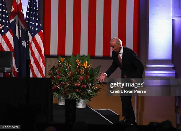 Vice-President Joe Biden trips on a step as he arrives to deliver a speech on the future of the U.S.-Australia relationship at Paddington Town Hall...