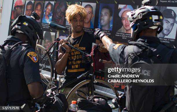 Protester is confronted by police during a rally outside the Republican National Convention in Cleveland, Ohio on July 19, 2016. The Republican Party...