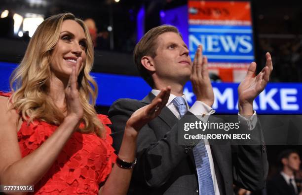 Eric Trump , son of Republican presidential nominee Donald Trump, and his wife Lara Yunaska applaud at the end of Donald Trump Jr's speech on the...