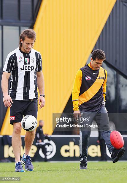 Ivan Maric of the Tigers, a soccer fanatic, gets to kick a soccer with Hernanes of Juventus who kicks an AFL football during a Richmond Tigers AFL...