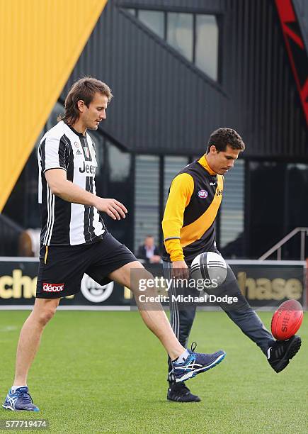 Ivan Maric of the Tigers, a soccer fanatic, gets to kick a soccer with Hernanes of Juventus who kicks an AFL football during a Richmond Tigers AFL...