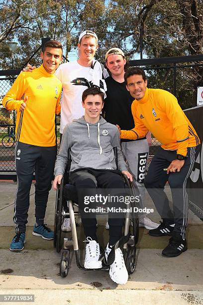 Jack Riewolt of the Tigers and his friends pose with Paulo Dybala and Hernanes of Juventus during a Richmond Tigers AFL and Juventus FC media...