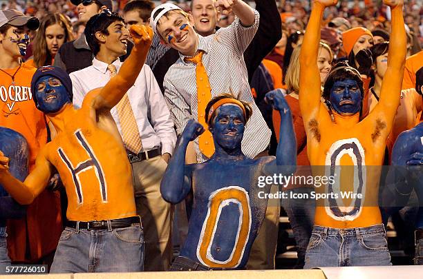 Painted Virginia fans cheer and dance in the stands. The Virginia Tech Hokies defeated the Virginia Cavaliers 42-13 at Scott Stadium in...