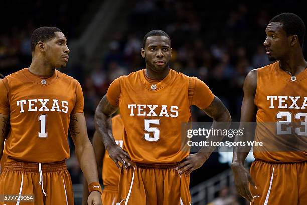 Texas Longhorns forward Gary Johnson , and guards Damion James and Jordan Hamilton come back from a timeout during the O'Reilly Auto Parts CBE...