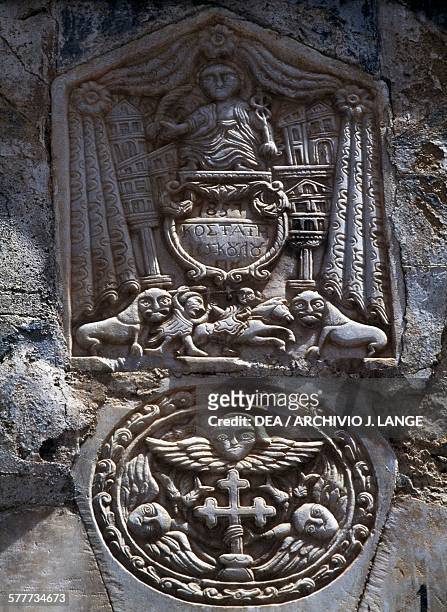 Relief with Latin cross, angels, lions and battle scene, Pyrgi, Chios Island, Greece.