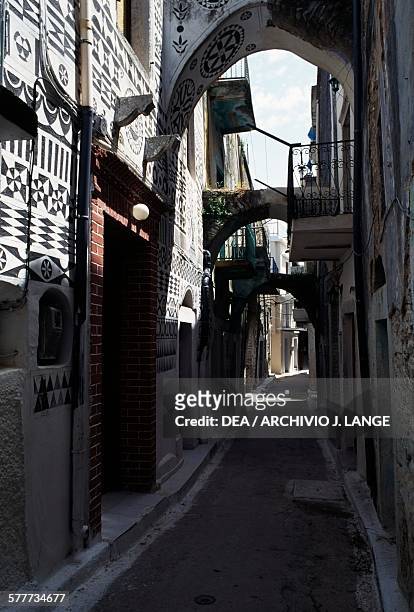 Houses with traditional decoration in an alley in Pyrgi, Chios island, Greece.