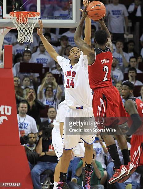March 2014 - Louisville Cardinals guard Russ Smith shoots one of his six second half three pointers over SMU Mustangs forward Ben Moore during the...