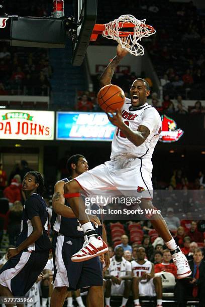 University of Louisville's Terrence Jennings dunks the basketball over top Oral Roberts University's Damen Bell-Holter and Dominique Morrison during...