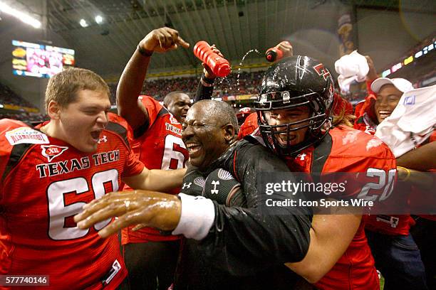 Texas Tech Head Coach Ruffin McNeill is drenched by players after Texas Tech's 41-31 victory over Michigan State at the Valero Alamo Bowl in San...
