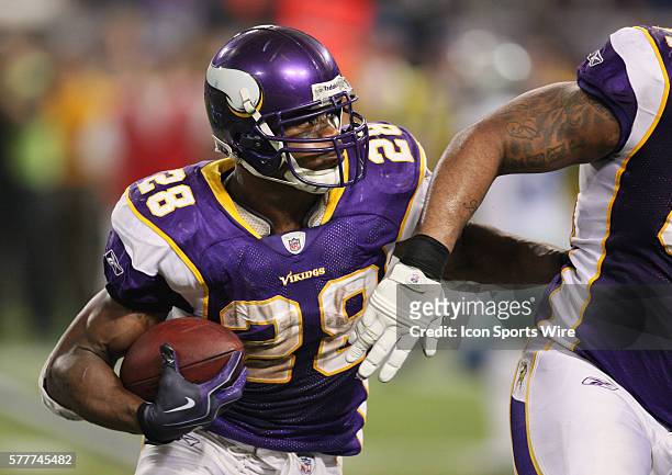 Minnesota Vikings running back Adrian Peterson carries the ball late in the game. The Minnesota Vikings defeated the Dallas Cowboys by a score of 34...