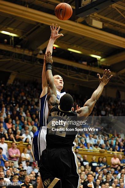 Duke forward Miles Plumlee shoots over Wake Forest guard L.D. Williams during a game between the Wake Forest Demon Deacons and the Duke Blue Devils...