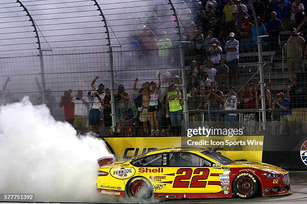 Joey Logano celebrates with a burnout after winning the Irwin Tools Night Race at the Bristol Motor Speedway.