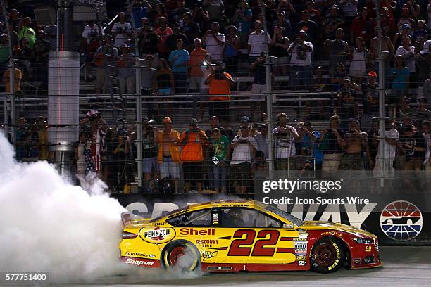 Joey Logano celebrates with a burnout after winning the Irwin Tools Night Race at the Bristol Motor Speedway.