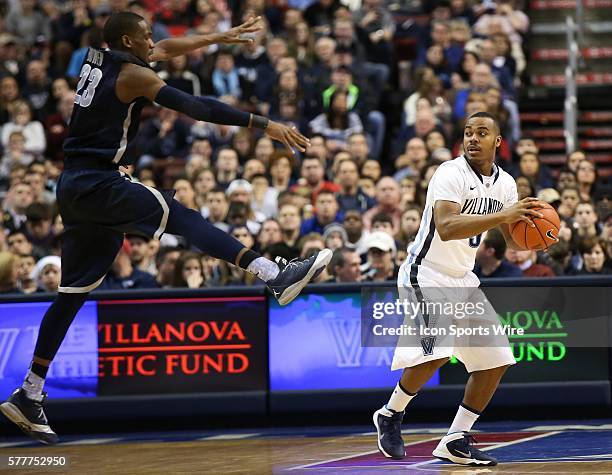 Villanova Wildcats guard Tony Chennault looks for an open passing lane past leaping Georgetown Hoyas forward Aaron Bowen in an Big East basketball...