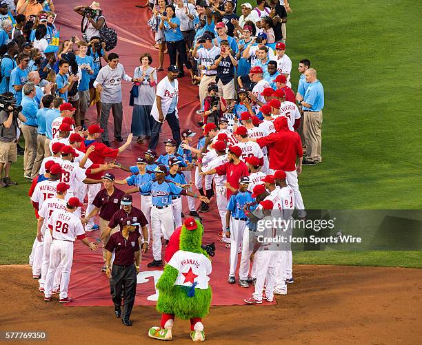 The Philadelphia Phillies pay tribute to the Taney Dragons as the enter the baseball diamond on the red carpet before a Major League Baseball game...