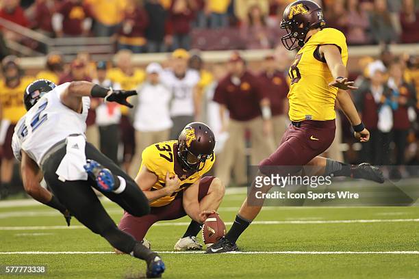 August 28, 2014 Gophers kicker Ryan Santoso kicks the extra point as punter Peter Mortell holds the ball at the Minnesota Gophers game versus Eastern...