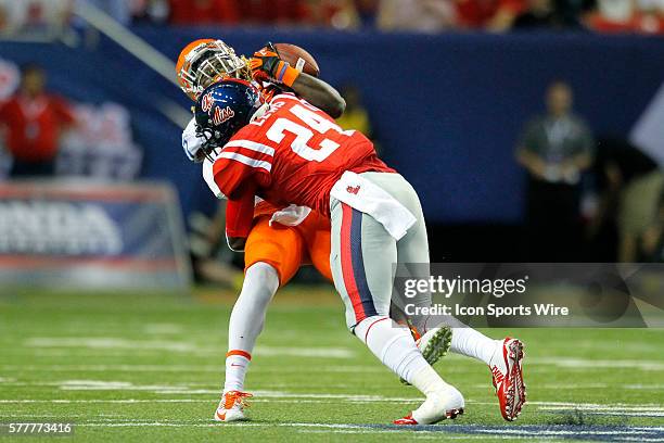 Boise State Broncos running back Jay Ajayi is hit by Mississippi Rebels linebacker Keith Lewis in first half action of the Ole Miss Rebels v Boise...