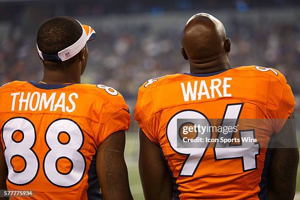 Denver Broncos defensive end DeMarcus Ware and wide receiver Demaryius Thomas look on from the sideline during the final NFL preseason game between...
