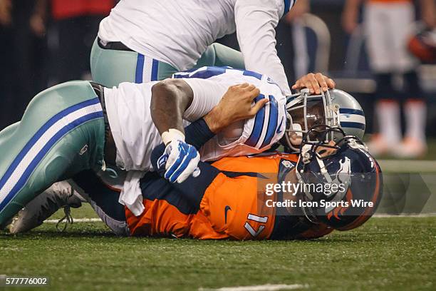 Denver Broncos quarterback Brock Osweiler is hit hard by Dallas Cowboys linebacker Anthony Hitchens during the final NFL preseason game between the...